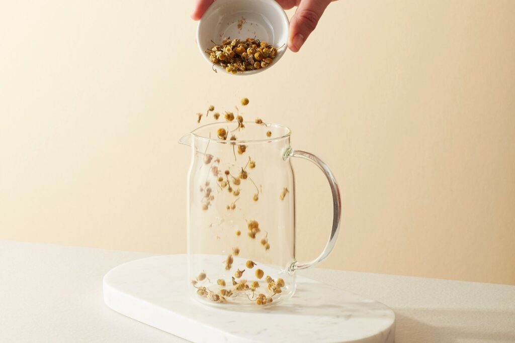 Loose leaf chamomile blossoms in to a large teapot