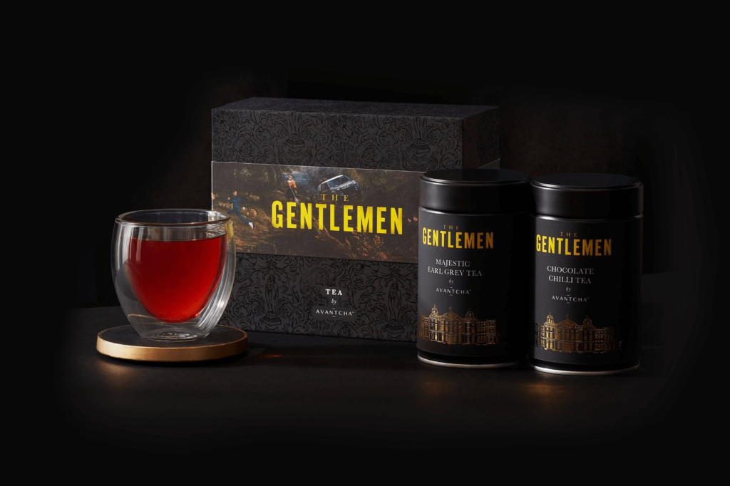 Two tins of loose leaf tea and cup of brewed tea as a gift set